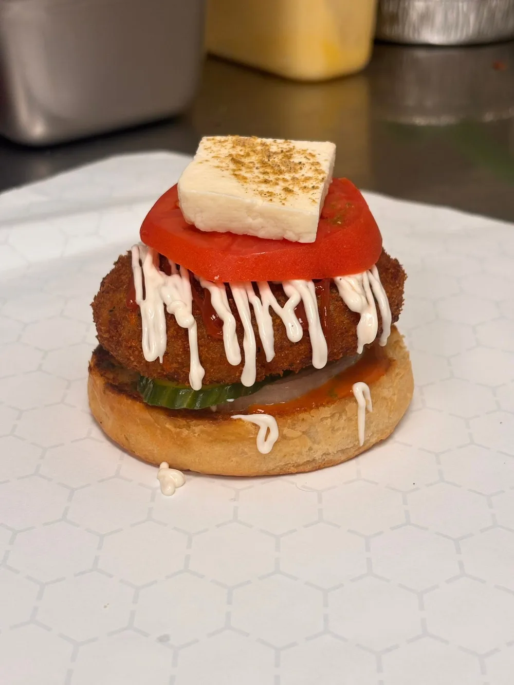 Loaded veggie noodle burger with tomato, paneer and sauces
