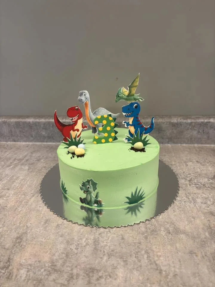 Dinosaur themed birthday cake in green buttercream