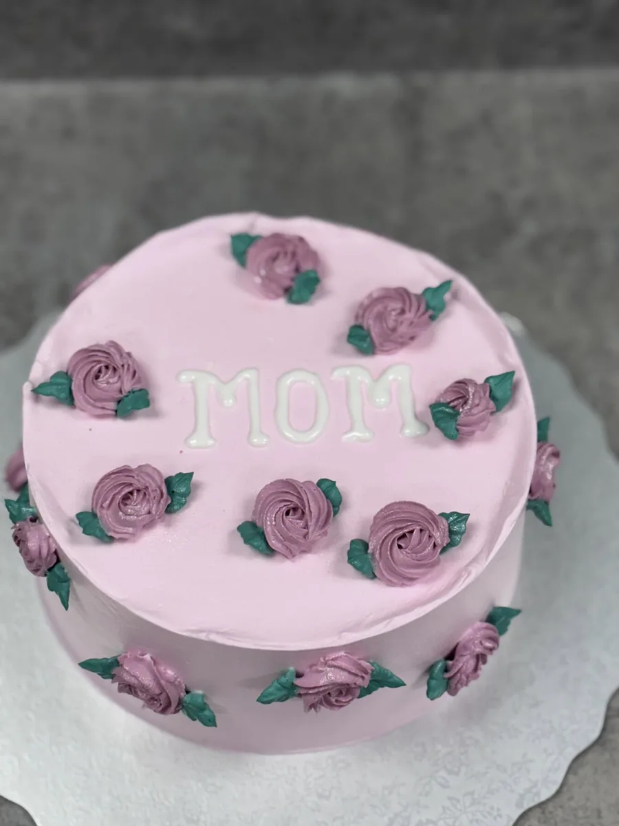 Pink celebration cake with piped buttercream roses